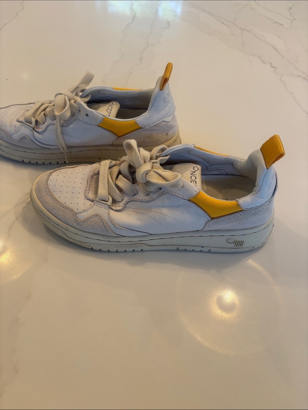 Oncept white and yellow sneakers.